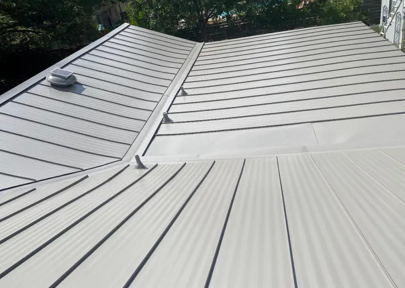 Solar attic fan installed on a metal roof for Roof Ventilation in Center Point
